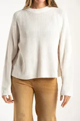Sweater de punto de algodón con diseño oversize, cuello redondo y mangas largas. Presenta un detalle de costura lateral en color contrastante.