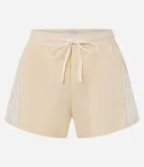 Short deportivo femenino tipo runner de la marca Get Over, color beige, confeccionado en poliamida con cintura elástica, cordón de ajuste y recortes con hilo reflectante.