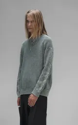 Sweater de cuello redondo con diseño de tejido texturizado en color verde y blanco. Presenta un calce relajado y terminaciones en punto rib en el cuello.