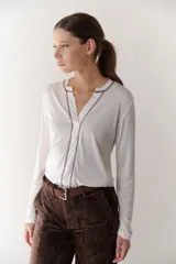 Remera manga larga color borgoña con cuello en V y costuras decorativas verticales.