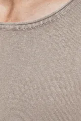 Sweater de punto color beige, de manga larga y cuello redondo.