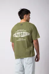 Remera de algodón con estilo deportivo, color verde oliva con efecto de lavado gastado. Presenta el número 15 estampado en blanco en el frente y detalles de costuras con vivos blancos en los hombros. Posee cuello redondo y corte holgado.