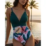 Malla enteriza con diseño combinado, parte superior en color verde petróleo con borde festoneado y parte inferior con estampado floral sobre fondo negro.
