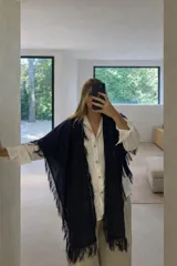 Chal de tejido liviano con mezcla de lino, de color azul marino, con terminaciones desflecadas en todo su contorno.