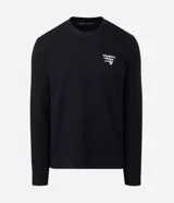 Remera de manga larga confeccionada en tejido de algodón con textura tipo waffle. Presenta un diseño de calce regular con estampado tipográfico en la espalda y cuello redondo.