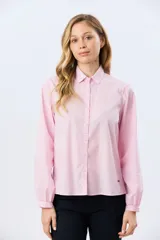 Camisa de manga larga con estampado de cuadros vichy en tono rosado, cuello camisero tradicional, cierre frontal con botones y frunces en los hombros.