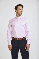 Camisa de vestir blanca de corte clásico, con cuello rígido, cierre frontal de botones y mangas largas con puños abotonados.