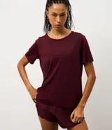Remera deportiva de manga corta con cuello redondo, confeccionada en poliamida y elastano. Presenta un diseño liso con detalle de recorte en la espalda.