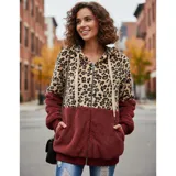 Campera tipo polar con cierre frontal, diseño combinado con estampado animal print en la parte superior y tejido de peluche blanco en la parte inferior. Cuenta con capucha con cordones ajustables y dos bolsillos frontales.