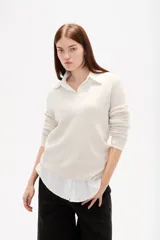 Sweater de tejido de punto color negro, con cuello en V y diseño holgado de manga larga.