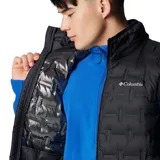 Chaleco acolchado de plumón Columbia, color negro, con cierre frontal completo, cuello alto y bolsillos laterales con cierre. Presenta tecnología HeatSeal™ de construcción sellada térmicamente y forro termorreflectante Omni-Heat™.