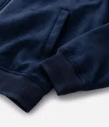 Chaqueta bomber de Marfinno en color tostado, con cierre frontal y cuello de tejido acanalado. Presenta un diseño liso con costuras horizontales y bolsillos funcionales.