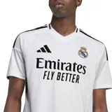 Camiseta de fútbol Adidas del Real Madrid, modelo 24/25, color blanco con detalles en negro. Presenta cuello de pico, tecnología AEROREADY y escudo del club bordado.