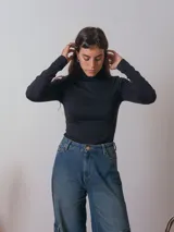 Polera negra de cuello alto y manga larga.