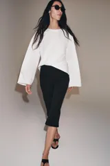 Camiseta de algodón con cuello redondo y mangas largas tipo ranglán. Presenta un corte regular y bajo recto.