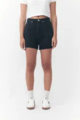 Short de denim negro de tiro alto, con bolsillos laterales y traseros, y cierre frontal con botón y cremallera.
