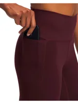 Calza deportiva de tiro alto en color bordó, confeccionada en tejido de punto elástico de alto rendimiento. Cuenta con bolsillos laterales y diseño ergonómico para mayor sujeción y comodidad durante el entrenamiento.