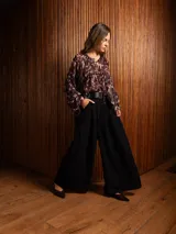 Pantalon tipo palazzo de corte amplio y tiro alto, con pinzas frontales, bolsillos laterales y cintura elástica.