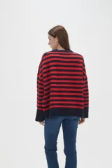 Sweater de tejido de punto con diseño de rayas horizontales en color rojo y azul marino, cuello redondo a la base y mangas largas con corte holgado.