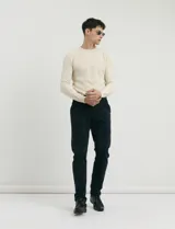 Sweater de punto con textura tipo waffle, color negro, de corte clásico con cuello redondo y mangas largas.