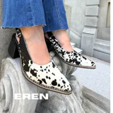 Stiletto destalonado de cuero con pelo natural y estampado animal print de vaca, con taco cuadrado de madera y puntera perfilada.