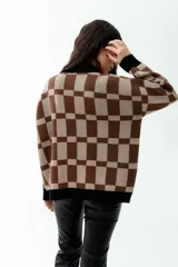 Cárdigan marrón con diseño a cuadros beige, con cuello, puños y borde inferior negros.
