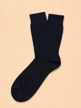 Medias de algodón color negro con estampado de pequeños puntos blancos, diseño clásico con puño elástico.
