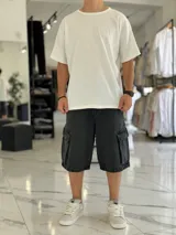 Bermuda de jean estilo cargo con bolsillos laterales con solapa, corte super baggy y lavado efecto desgastado.