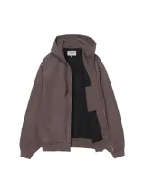 Campera OG Active de Carhartt WIP, color azul grisáceo, con capucha integrada, cierre frontal con cremallera metálica, bolsillos tipo canguro y parche con el logo de la marca en el bolsillo inferior.