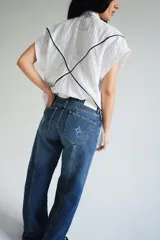 Pantalón de jean gris oscuro de corte recto, tiro medio y largo. Diseño con costuras verticales y lavado con sobreteñido.