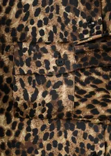 Camisa de tejido satinado con estampado de leopardo, corte recto, manga larga con puños abotonados, cuello camisero y cierre delantero con botones.