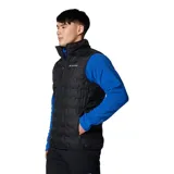 Chaleco acolchado de plumón Columbia, color negro, con cierre frontal completo, cuello alto y bolsillos laterales con cierre. Presenta tecnología HeatSeal™ de construcción sellada térmicamente y forro termorreflectante Omni-Heat™.