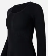 Vestido corto negro de punto acanalado con escote cuadrado y mangas largas. Detalle de textura diferenciada en la cintura.