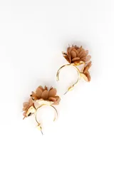 Aros tipo caravanas dorados con diseño de flores de metal y pétalos de tela negra en capas.