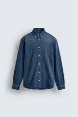Camisa de corte regular fit confeccionada en tejido de mezcla de algodón y cashmere. Presenta cuello con botones, cierre frontal de botones, mangas largas con puños abotonados y un acabado con efecto lavado.