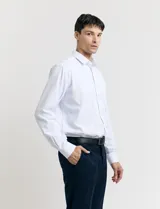 Ambo de corte clásico en color azul oscuro con sutil patrón de rayas verticales. Incluye saco de dos botones con solapas de muesca y bolsillos con solapa, junto con pantalón de vestir a juego de corte recto.