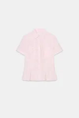 Camisa entallada color rosa pálido, con cuello solapa, manga corta con vuelta y trabilla. Presenta dos bolsillos de plastrón en el delantero y cierre frontal con botones.