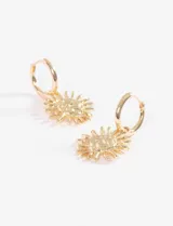 Caravanas de tipo argolla pequeña con dije colgante en forma de sol con superficie texturada y acabado dorado.