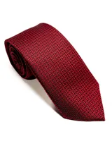 Corbata de seda azul marino con estampado paisley en tonos rosados y blancos.