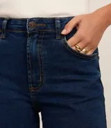 Short de jean azul oscuro, de tiro medio, con trabillas, bolsillos delanteros y traseros, cierre con botón y cremallera, y costuras contrastantes.