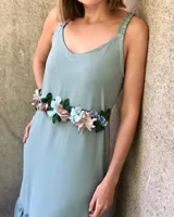 Cinto de flores bordadas con cadena ajustable en la parte trasera.