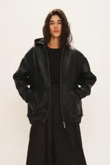 Campera Billie de cuero de oveja negro, con capucha, cierre frontal, bolsillos laterales y puños y cintura elastizados.