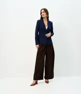 Blazer azul marino de corte entallado y largo medio, confeccionado en punto Roma con viscosa. Presenta cuello con solapa, manga larga, cierre frontal con dos botones y bolsillos con tapa.
