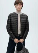 Campera acolchada de diseño recto y cuello redondo, con cierre frontal de cremallera y mangas largas. Cuenta con acabado repelente al agua y bolsillos laterales con cierre.