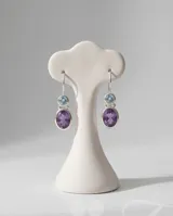 Caravanas colgantes de plata 925 con diseño de doble piedra facetada: una piedra superior circular de agua marina y una piedra inferior ovalada de amatista, ambas engarzadas en plata.