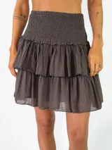 Pollera corta color marrón oscuro, con diseño de múltiples volados y cintura fruncida elástica.