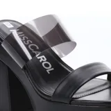 Sandalias de plataforma Miss Carol modelo Karachi, color negro, con taco cuadrado alto y tiras combinadas: una tira frontal de cuero sintético y una tira superior de material transparente.