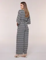 Enterito de calce relajado con caída fluida, escote en V cruzado estilo wrap, mangas tres cuartos estilo kimono y pantalón wide leg. Cuenta con cinto textil a tono para anudar en la cintura y bolsillos laterales, con diseño estampado geométrico en blanco y negro.