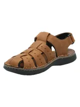 Sandalia de cuero color marrón con diseño de tiras entrelazadas y perforaciones decorativas. Cuenta con ajuste de velcro en el tobillo y suela de poliuretano negra con costuras visibles.