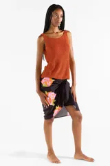 Pareo negro con estampado de flores abstractas en tonos fucsia y naranja.